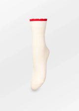 White sock with red trim on a light gray background